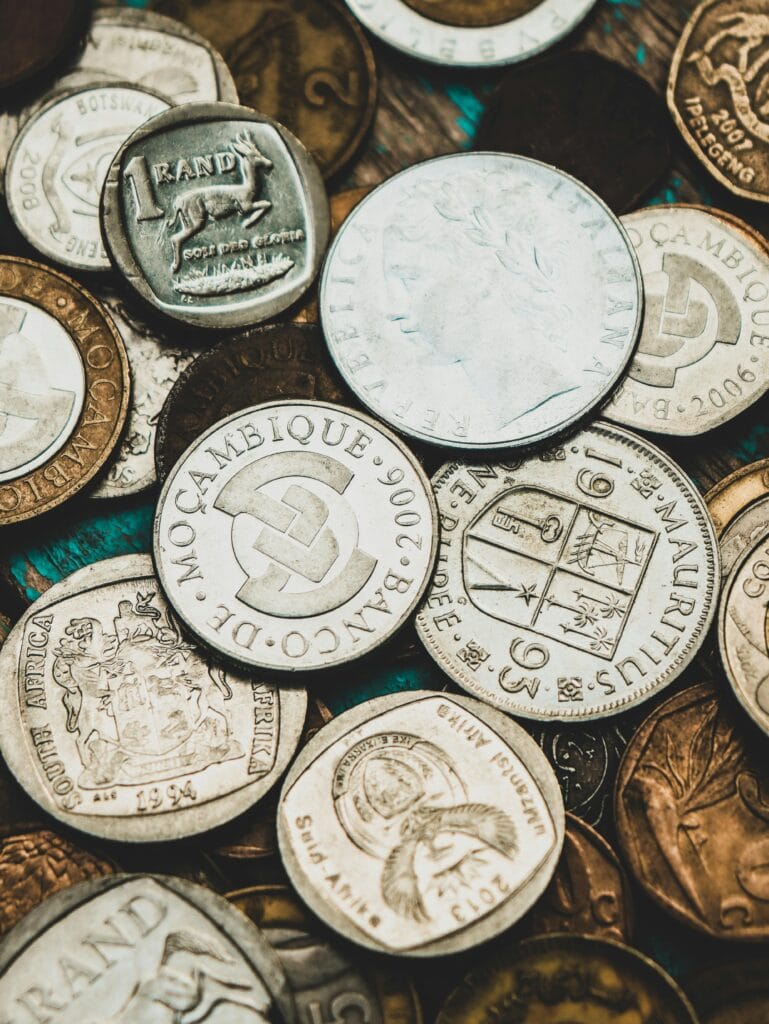 Close-up shot of various international coins showcasing currency diversity.